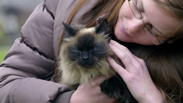 Woman hugging Birman cat