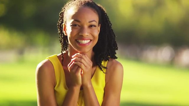 Happy African woman smiling in a park