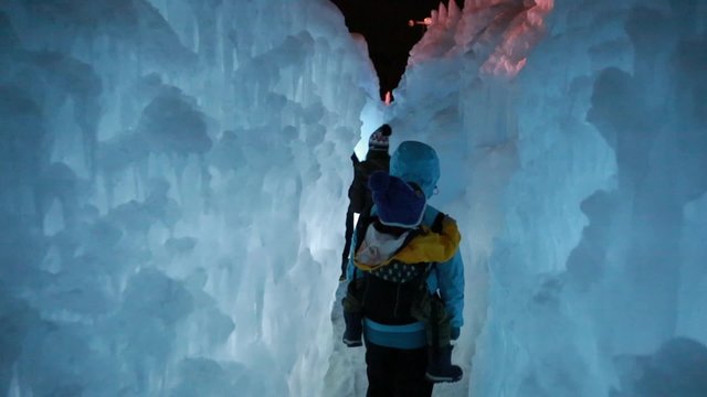 families walking in a ice castle