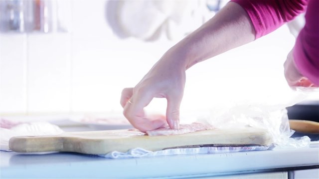 Woman Preparing and Marinating Meat With Hammer