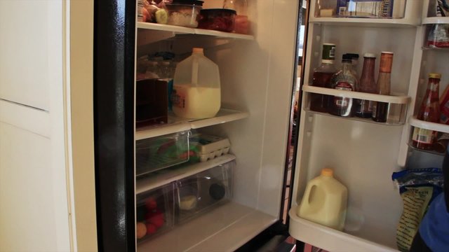 Man takes milk out of fridge