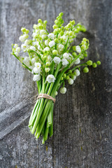 lilly of the valley on wooden surface