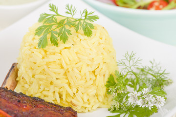 Saffron Rice - Steamed rice seasoned with saffron and garnished with coriander.
