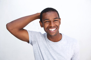 Smiling african american guy with hand in hair