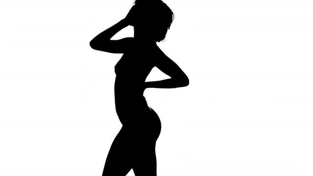 Silhouette of nude African woman dancing