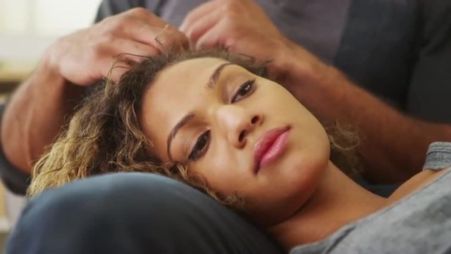 Closeup of girlfriend lying on boyfriend's lap