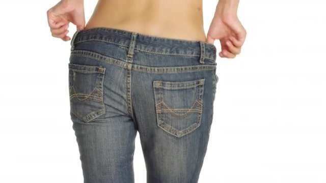Attractive Chinese woman putting on a pair of jeans