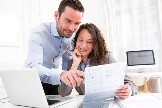 Young attractive couple doing paperwork