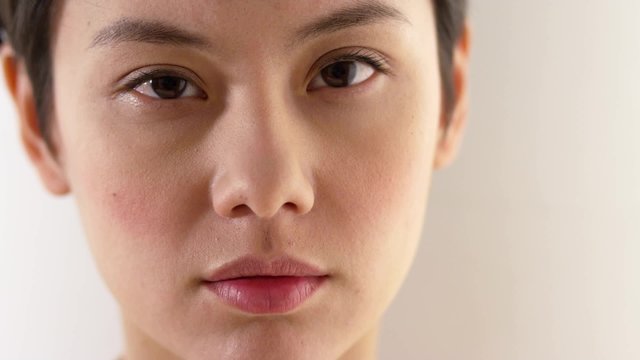Close up of serious Asian woman's face