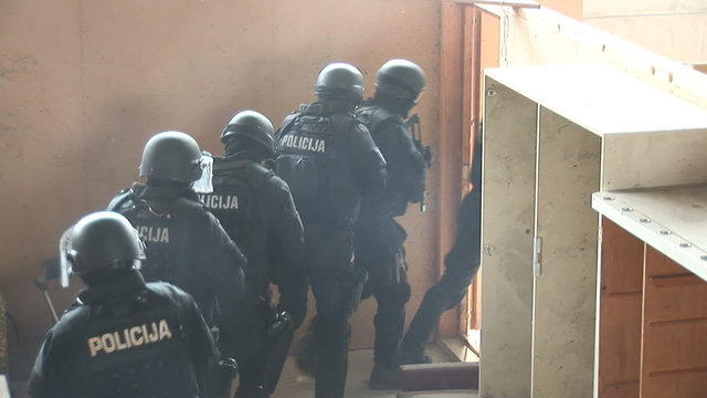 Armed special police arresting and taking the criminal