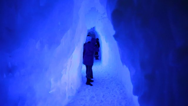 couple walking in an ice cave