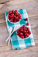 Cherries in a bowl on the table. The view from the top. Crop, orchard, berries. Healthy nutrition....