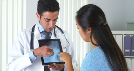 Mexican doctor explaining x-ray to patient