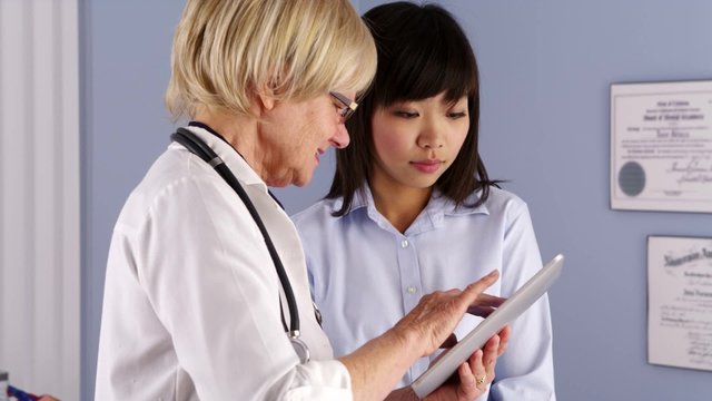 Senior doctor explaining xrays to patient