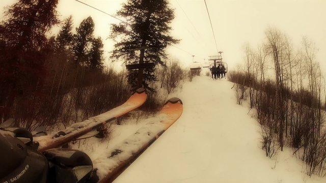 a skier at a mountain resort on chair lift