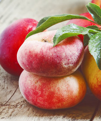 Assortment of peaches: big peaches, nectarines, flat peaches wit
