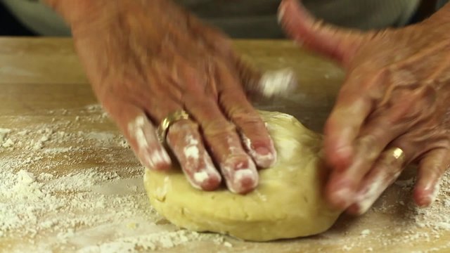 a woman forming a pie crust dough