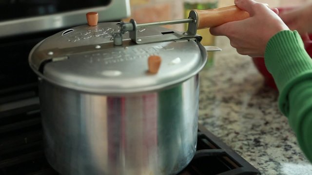 Woman Making Popcorn On The Stove