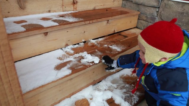 toddler playing outside in snow