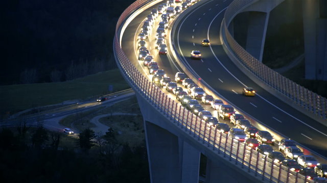 Vehicles headlights shining while standing in traffic jam