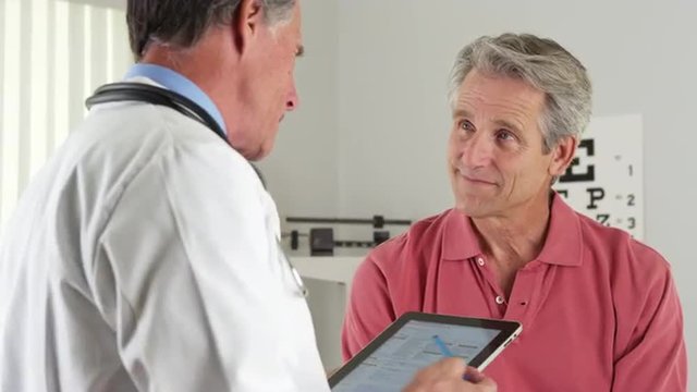 Senior doctor talking with old patient