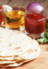 Homemade tortilla on the board with vegetables, selective focus