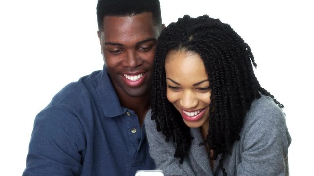 Happy young Black couple taking selfie together and laughing