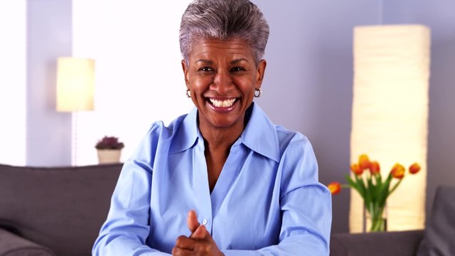 Happy Mature African Woman Talking To Camera