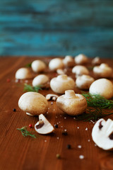 Cultured mushrooms champignons on wooden rustic background