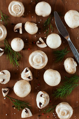 Cultured mushrooms champignons on wooden rustic background
