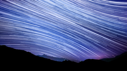 Star trail effect over mountain night sky. - 86810969