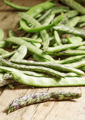Fresh green beans on wooden table, selective focus