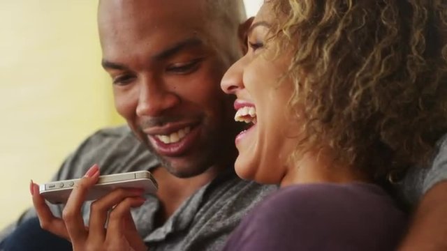 Black couple talking on smartphone