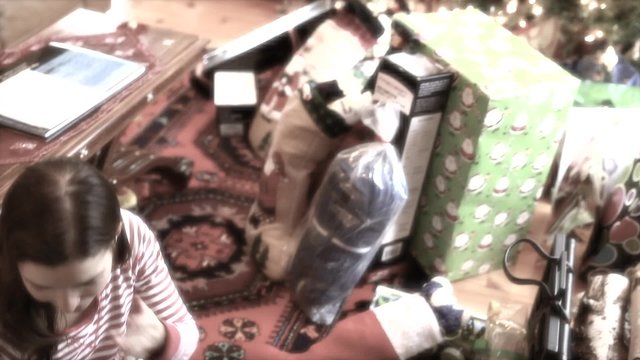 a mother and boy opening a present on christmas morning