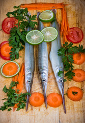 Fresh fish on wooden kitchen board