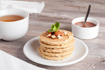 pancakes with nuts, decorated mint for breakfast, horizontal