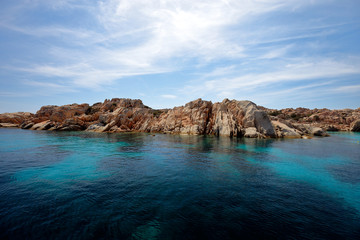 Fototapeta na wymiar Crystal clear waters in a blue-turquoise bay in Rhodes