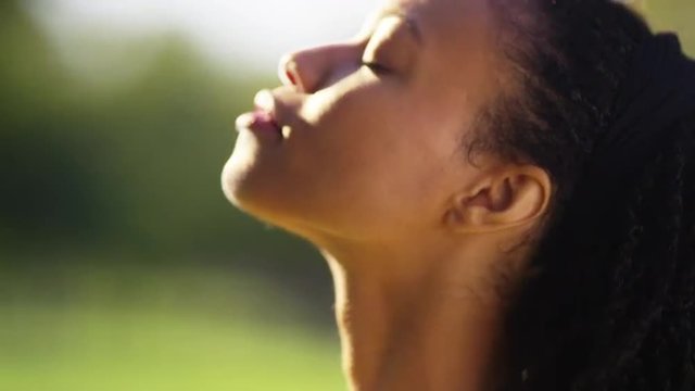 Beautiful black woman feeling the sun on her face