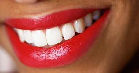 Closeup of a woman smiling with red lipstick