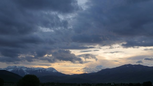 Timelapse storm clouds over mountain range