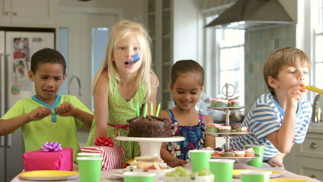 Group Of Children Celebrating Birthday With Cake And Gifts