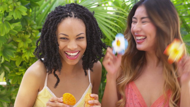 African American and Japanese friends laughing and being silly on vacation