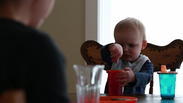 toddler and mother eating breakfast at table