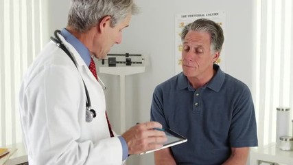 Senior doctor and patient talking in the office - Powered by Adobe