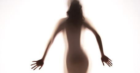 Fototapeta premium Attractive Mexican woman standing behind curtain