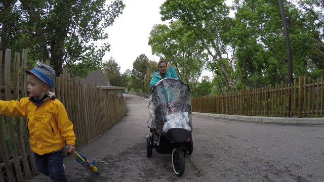 A gimbal shot of a family at the Hogle zoo on a rainy day
