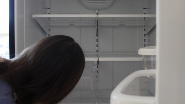 Woman putting bin back in after cleaning