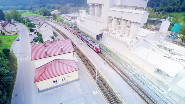 Train arrive on railway station aerial shot