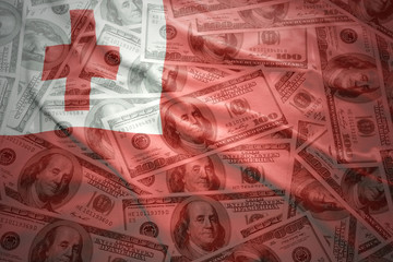colorful waving tonga flag on a american dollar money background