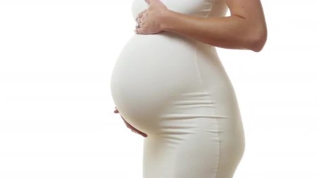 Pregnant woman dancing and rubby stomach